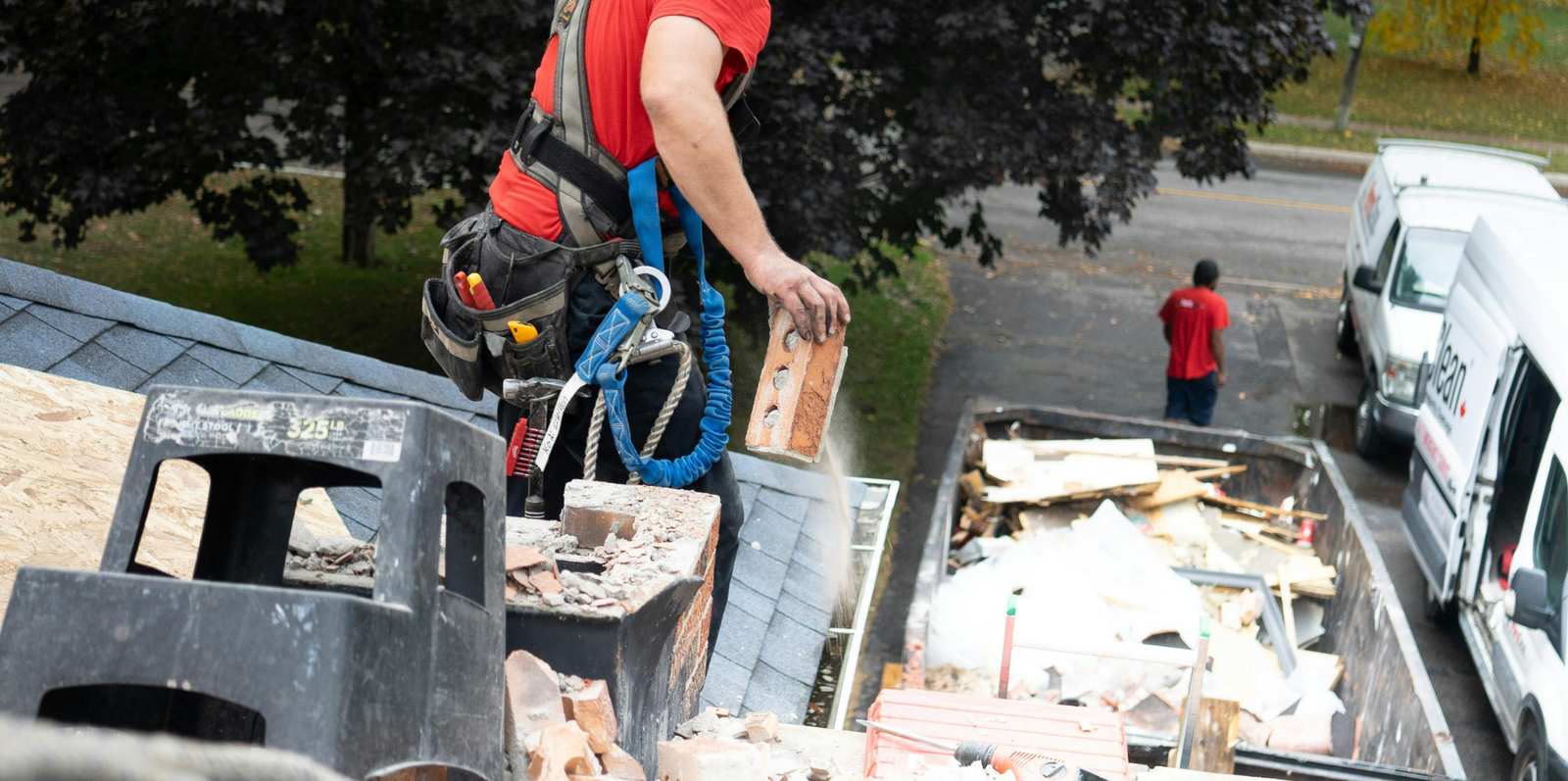 Demolition debris being removed into dumpster